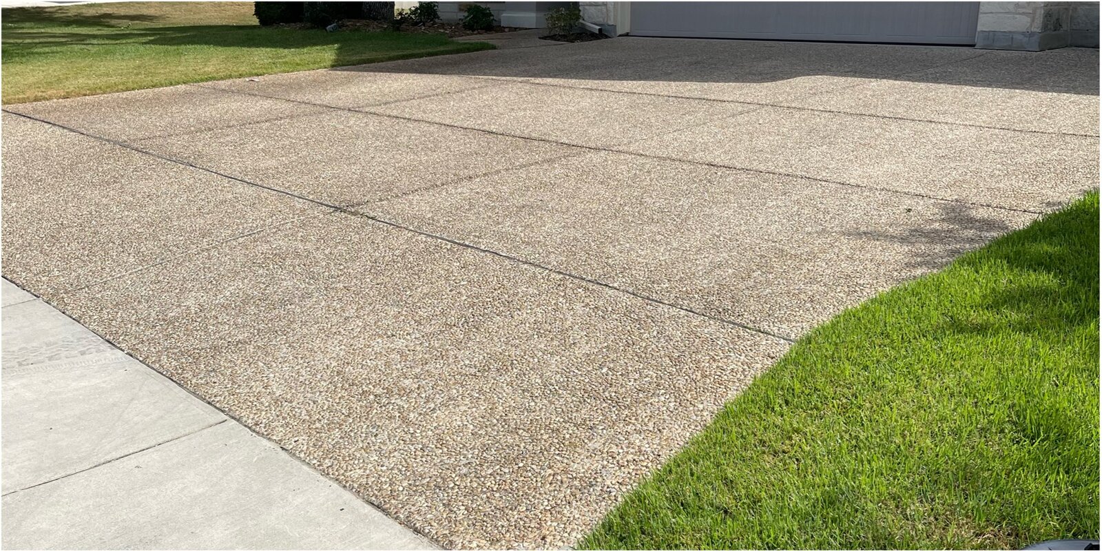 Before: dirty exposed-aggregate driveway in San Antonio